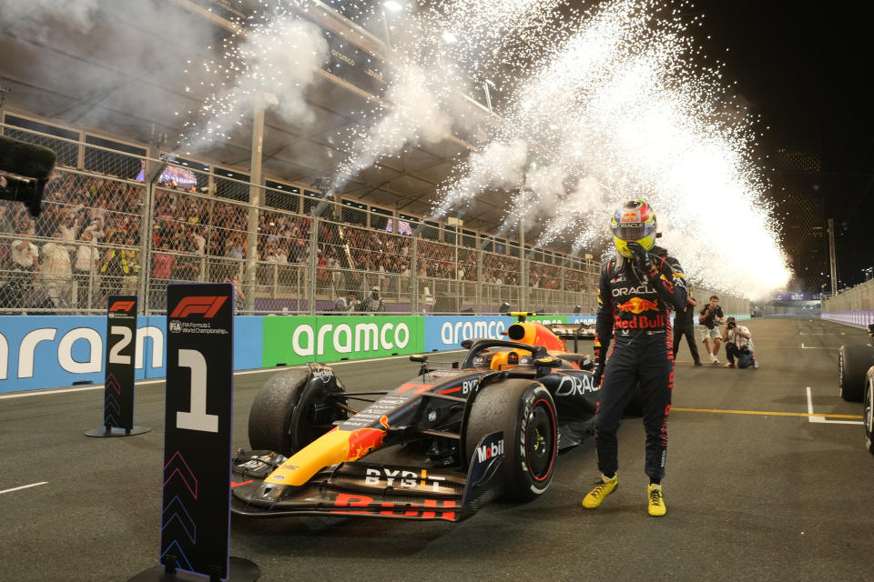 Red Bull driver Sergio Perez of Mexico stand next to his car after he won the Saudi Arabia Formula One Grand Prix at the Jeddah corniche circuit in Jeddah, Saudi Arabia, Sunday, March 19, 2023. (AP Photo/Luca Bruno, Pool)