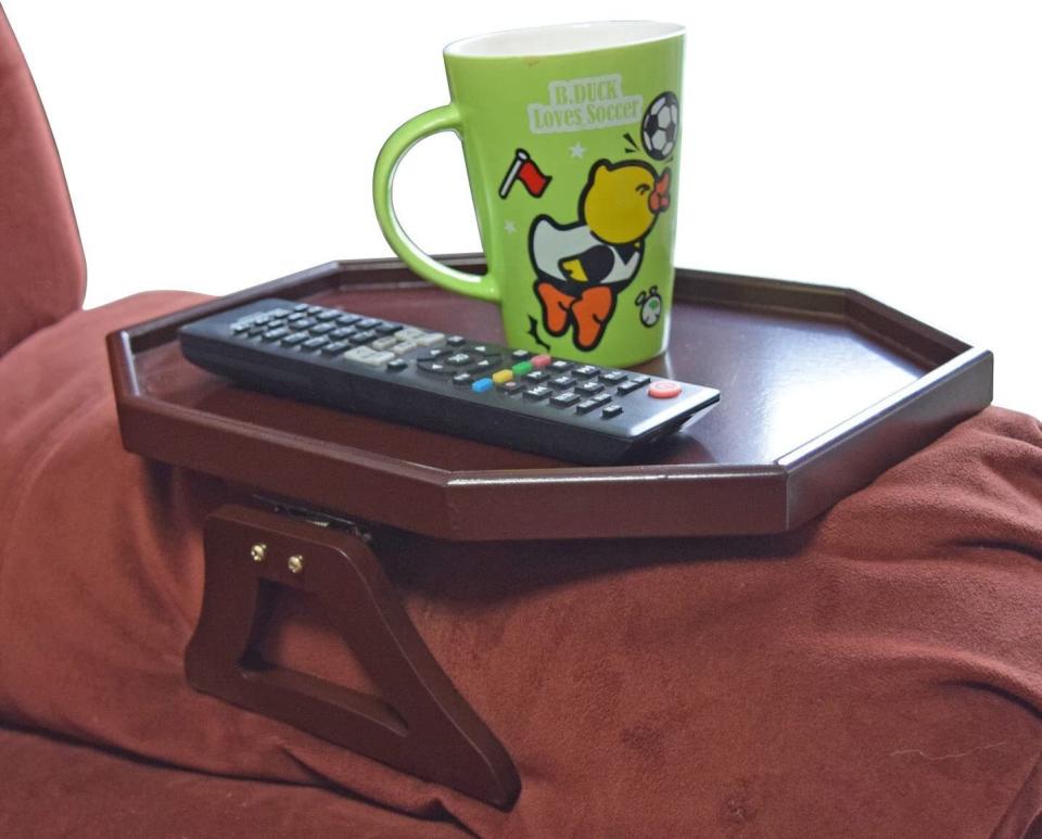 Perfect for that side where there's zero space to squeeze in a side table for your beverages and the remote.<br /><br /><strong><a href="https://www.amazon.com/Wooden-Armrest-Organizer-Romote-Cherry/dp/B013B74U5O?&amp;linkCode=ll1&amp;tag=huffpost-bfsyndication-20&amp;linkId=f084cac85568c87fc063bc158d61e695&amp;language=en_US&amp;ref_=as_li_ss_tl" target="_blank" rel="noopener noreferrer">Get it from Amazon for $24.99+ (available in two colors).</a></strong>