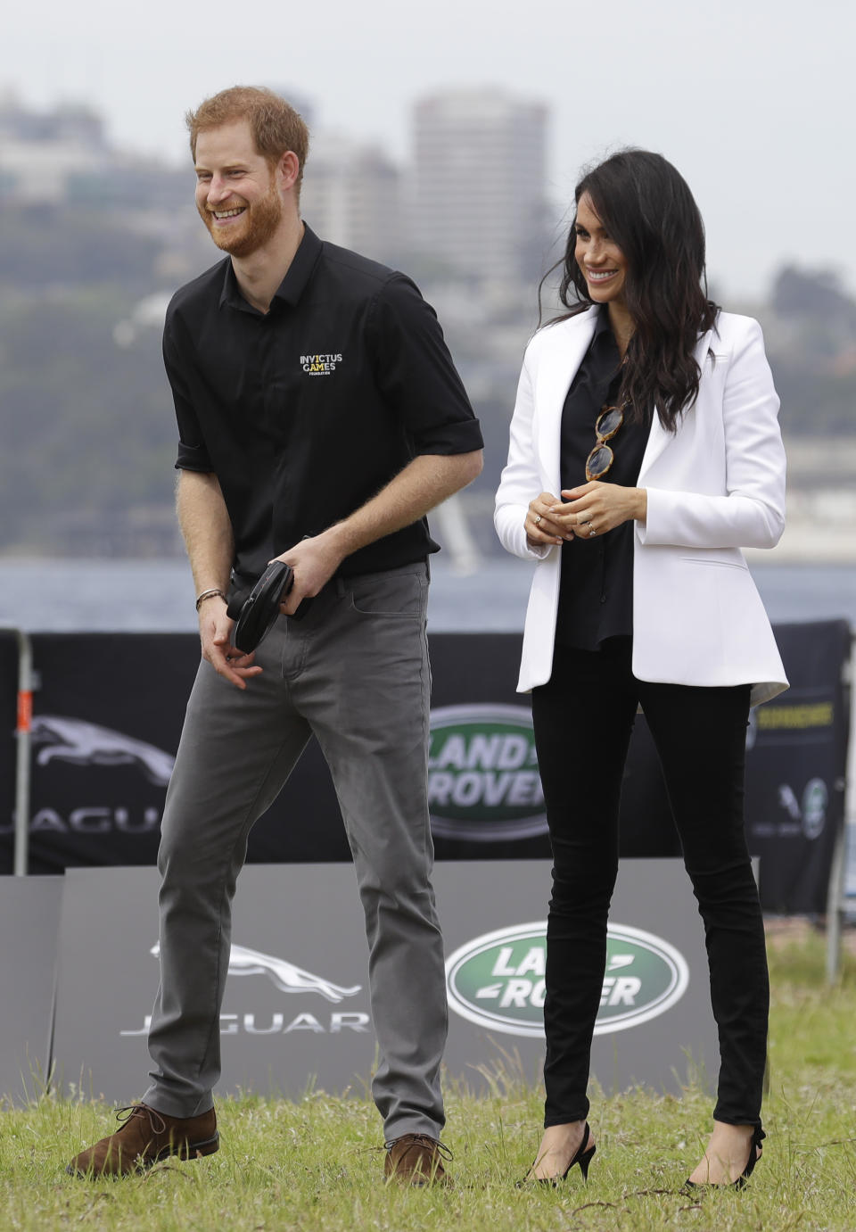 Britain's Prince Harry operates a remote control car with Meghan, Duchess of Sussex at the Invictus Games driving challenge on Cockatoo Island in Sydney, Australia, Saturday, Oct. 20, 2018. Prince Harry and his wife Meghan are on day five of their 16-day tour of Australia and the South Pacific. (AP Photo/Kirsty Wigglesworth)