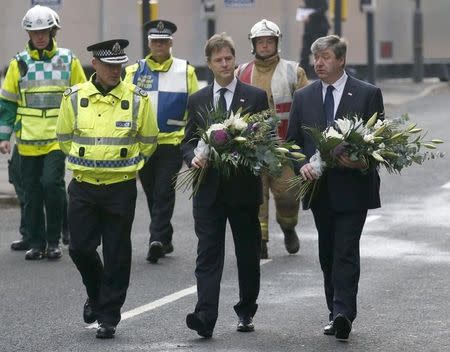 Britain's deputy prime minister Nick Clegg (3rd R) and Scottish Secretary Alistair Carmichael (R) arrive with flowers near a helicopter crash scene in central Glasgow, Scotland December 3, 2013. REUTERS/Russell Cheyne