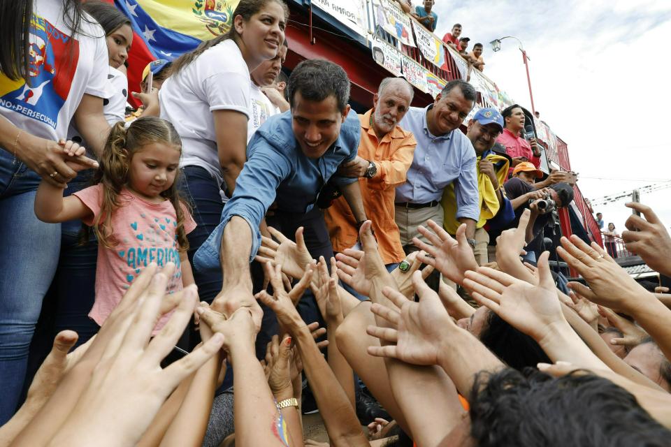 Venezuela's opposition leader and self-proclaimed interim president Juan Guaido greets supporters during a visit to Socopo in Barinas state, Venezuela, Saturday, June 1, 2019. Guaido is taking his campaign to oust President Nicolas Maduro to the birthplace of Hugo Chavez, the socialist leaders' mentor. (AP Photo/Ariana Cubillos)