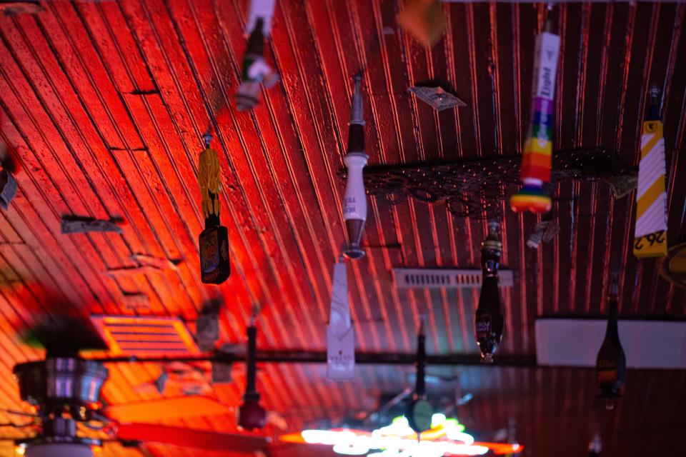 Beer taps, dollar bills and other decor hang from the ceiling of the Brass Rail Tavern, 401 S.E. Emmett St.