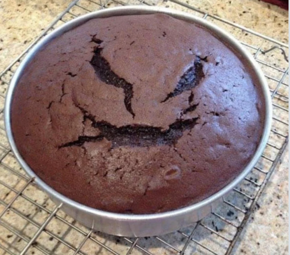 chocolate cake that's got cracks in the shape of a scary face