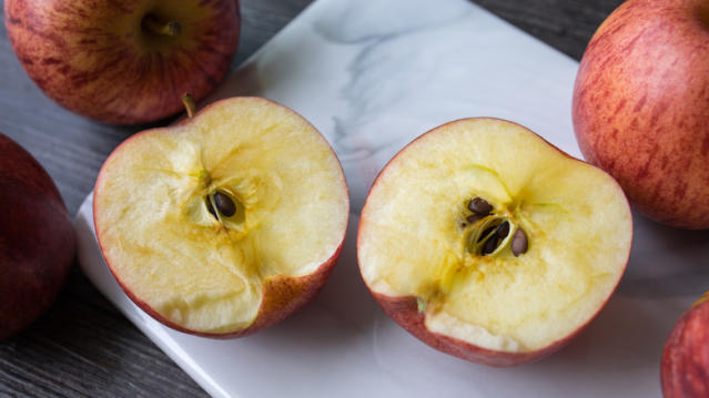 Why do apple slices turn brown after being cut?