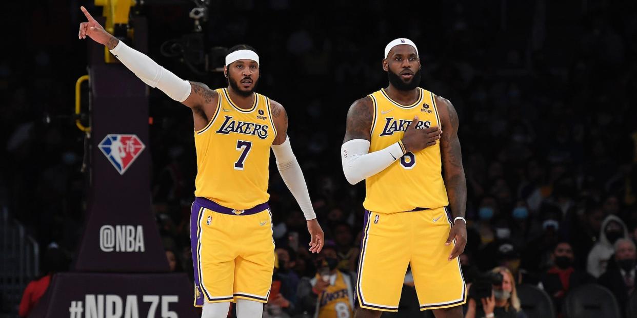 Carmelo Anthony points while standing next to LeBron James during a game.