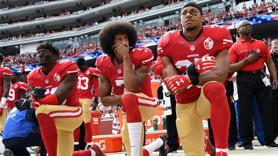 Kaepernick (centre) seen kneeling during the national anthem. Pic: Getty