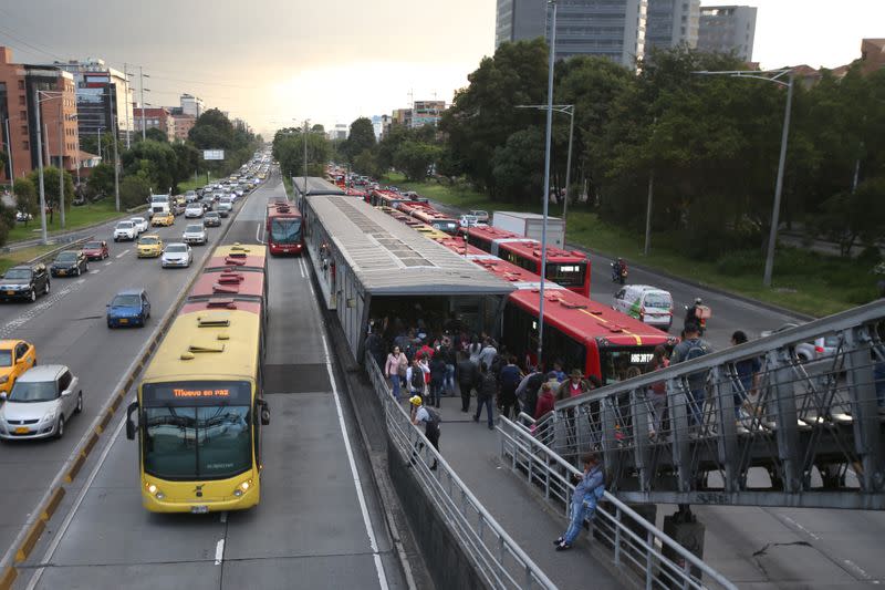 Transmilenio users walk at a station in Bogota