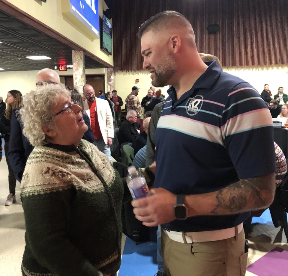 Former Freewill Elementary School teacher Cathy Contino shares a story with Kyle Kennedy, co-owner of K2 Brothers Brewing, which opened a new location at the former school in Wayne County.