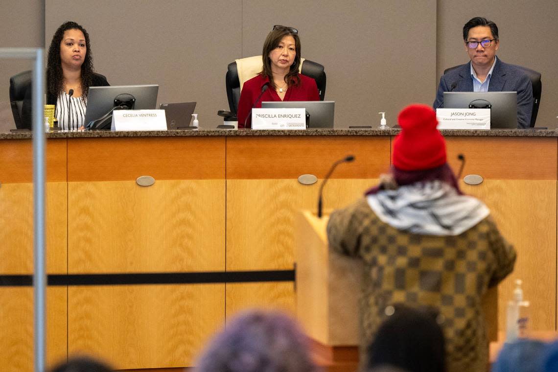 Pricilla Enriquez, center, chair of the Sacramento Arts, Culture and Creative Economy Commission, listens with commissioners Cecelia Ventrees, left, and Jason Jong in February as community members criticize the Wide Open Walls murals in Little Saigon.