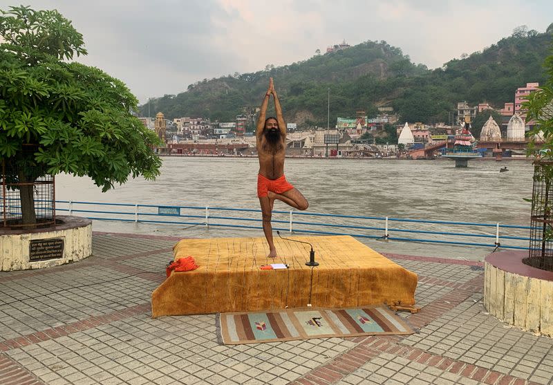 FILE PHOTO: India's yoga guru Baba Ramdev performs yoga on the banks of the river Ganges ahead of International Yoga day, in Haridwar