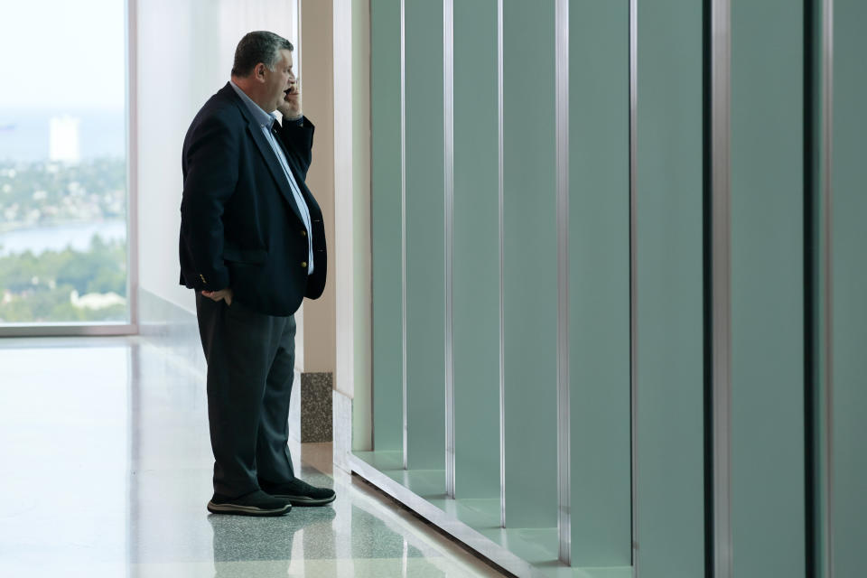 Tony Montalto, father of murder victim Gina Montalto, makes a phone call in the hallway after former Marjory Stoneman Douglas High School School Resource Officer Scot Peterson was found not guilty on all charges at the Broward County Courthouse in Fort Lauderdale, Fla., on Thursday, June 29, 2023. Peterson was acquitted of child neglect and other charges for failing to act during the Parkland school massacre, where 14 students and three staff members were murdered. (Mike Stocker/South Florida Sun-Sentinel via AP, Pool)