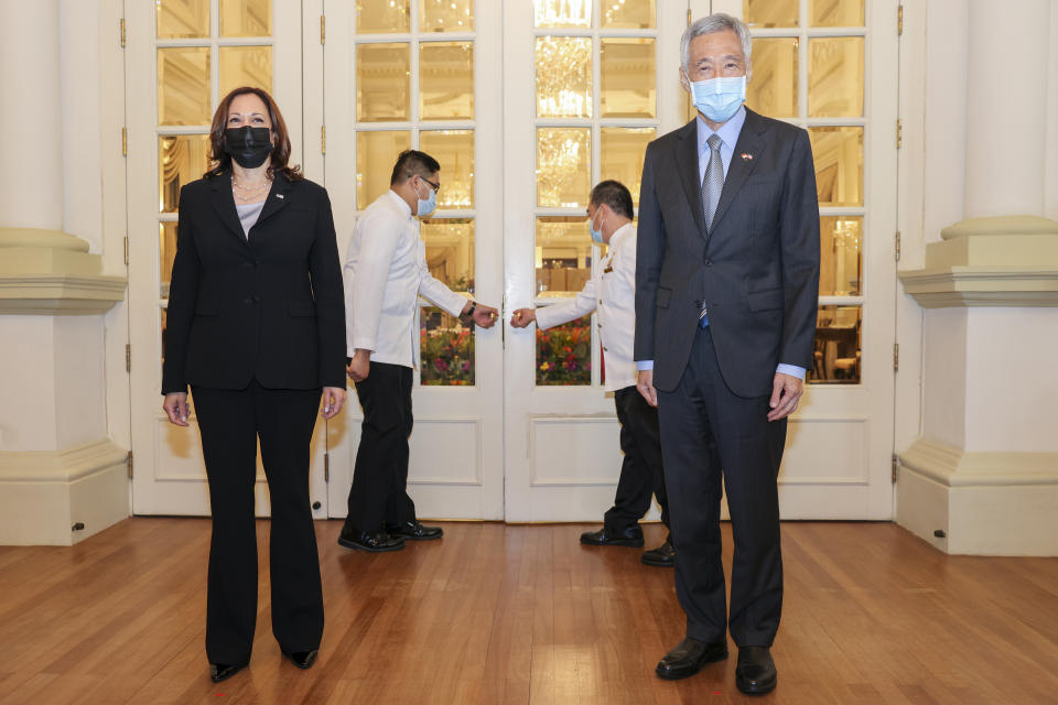 U.S. Vice President Kamala Harris, left, stands next to Singapore's Prime Minister Lee Hsien Loong before their bilateral meeting at the Istana in Singapore Monday, Aug. 23, 2021. (Evelyn Hockstein/Pool Photo via AP)