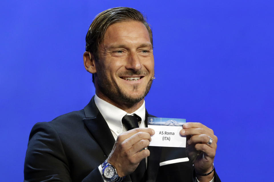 Former Italian player Francesco Totti shows the name ofAS Roma, who will play in Group C during the UEFA Champions League draw at the Grimaldi Forum, in Monaco, Thursday, Aug. 24, 2017. (AP Photo/Claude Paris)