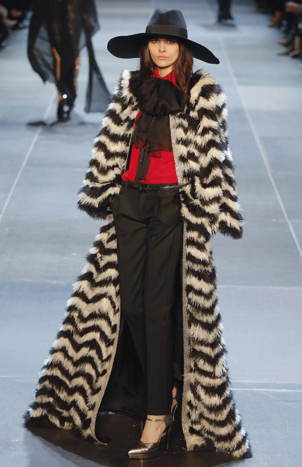 A model wears a creation by French-born fashion designer Hedi Slimane for St Laurent his ready to wear Spring-Summer 2013 collection presented in Paris, Monday, Oct. 1, 2012. (AP Photo/Jacques Brinon)