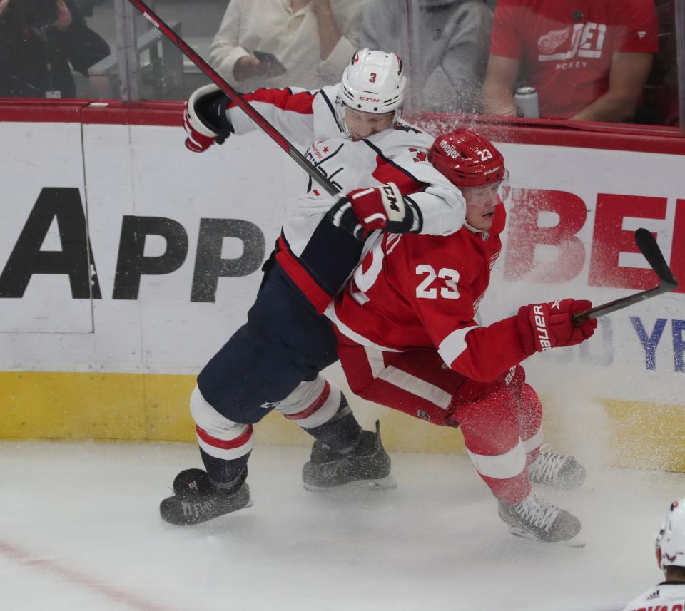 Detroit Red Wings left wing Lucas Raymond (23) is checked by Washington Capitals defenseman Nick Jensen (3) during second-period action at Little Caesars Arena in Detroit on Thursday, Nov. 3, 2022.