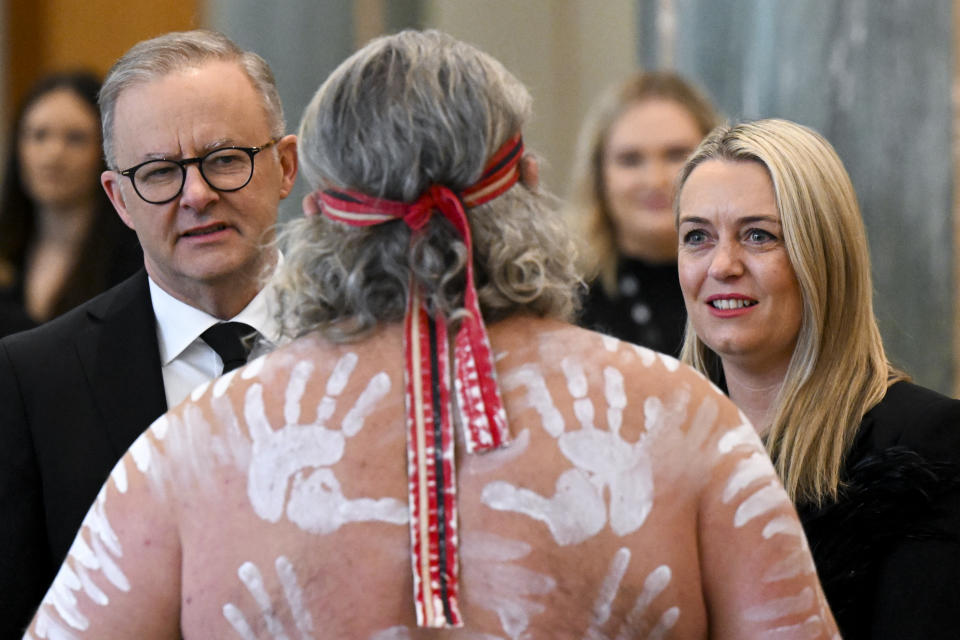 Mr Albanese and partner Jodie Haydon speak to an Indigenous dancer as they arrive for the national memorial service. Source: AAP