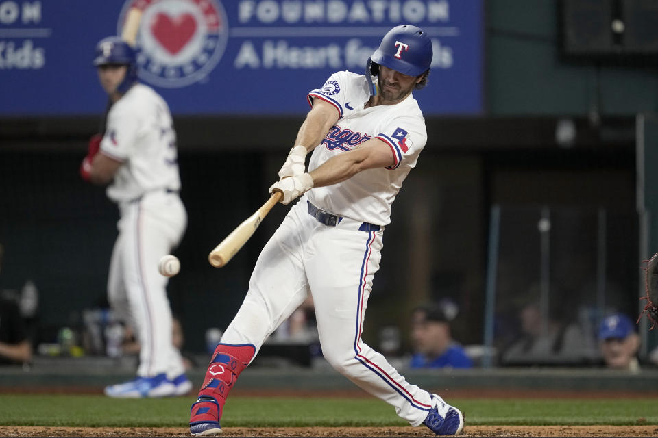 Texas Rangers' Josh Smith connects for a double in the eighth inning of a baseball game against the Washington Nationals in Arlington, Texas, Thursday, May 2, 2024. (AP Photo/Tony Gutierrez)