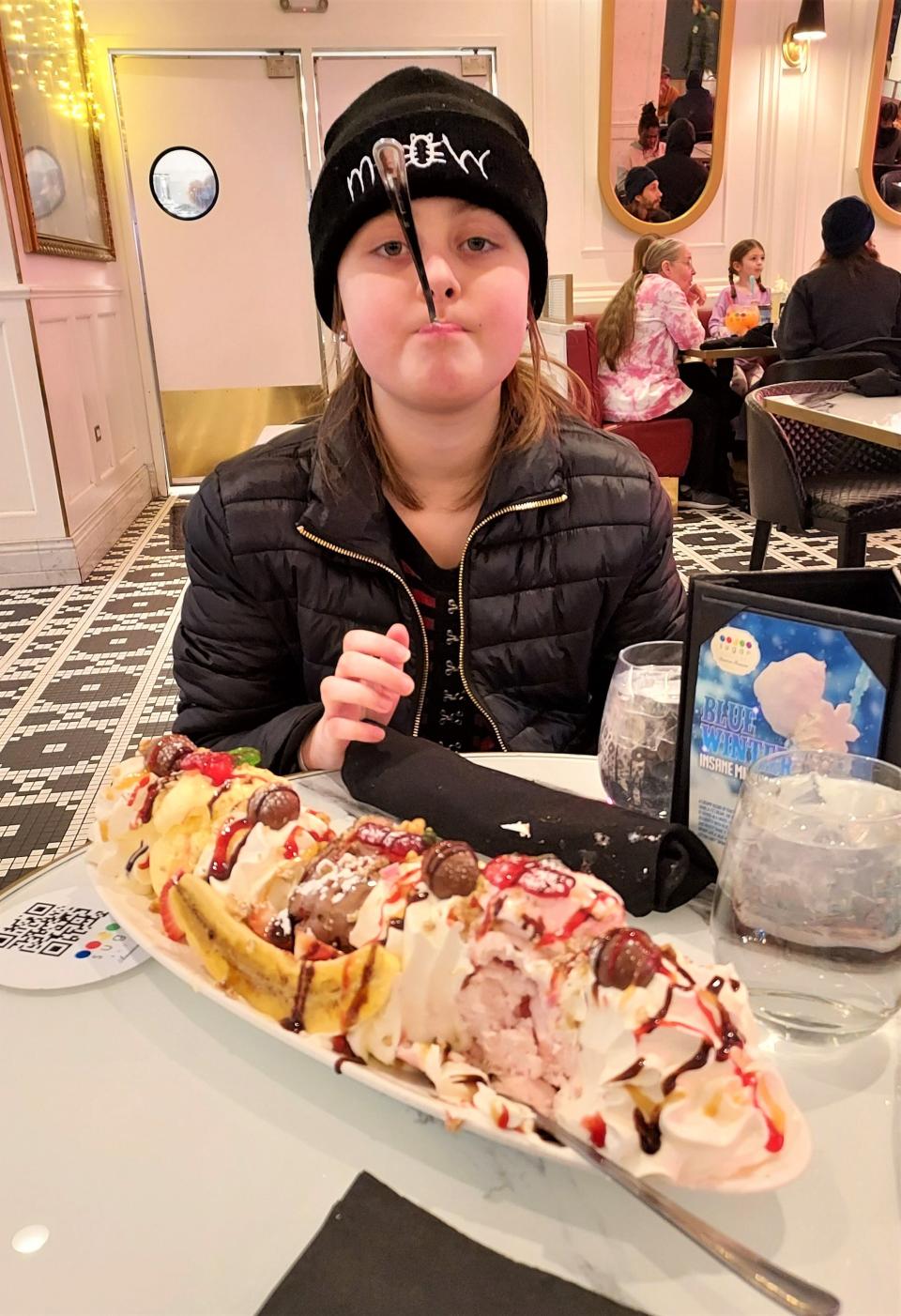 Nora Meek, 9, grabs a sweet treat between during her shopping trip at the Mall of America, thanks to Make-A-Wish America. Nora was diagnosed with a brain tumor in September.