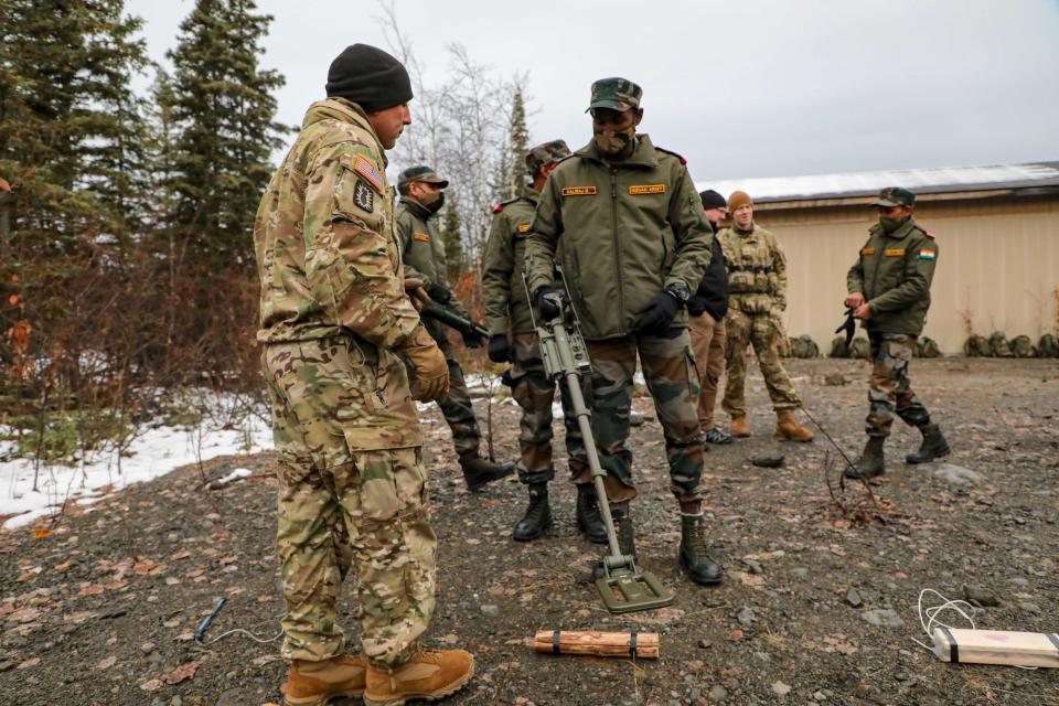 US and Indian soldiers use metal detector in Alaska