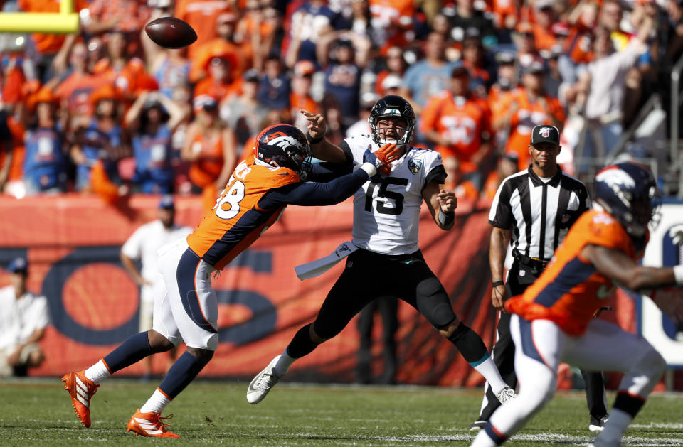 FILE - In this Sept. 29, 2019, file photo, Jacksonville Jaguars quarterback Gardner Minshew (15) throws a pass under pressure from Denver Broncos outside linebacker Von Miller, left, during the first half of an NFL football game in Denver. Denver has lost both home games on last-second field goals. ... One way to turn that around would be for star linebacker Miller to start getting to quarterbacks. Miller has 10½ sacks in his last 10 home games but just two sacks this season. (AP Photo/David Zalubowski, File)