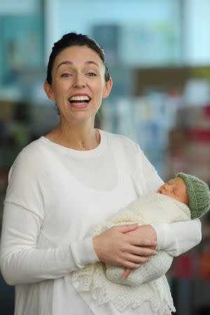 New Zealand Prime Minister Jacinda Ardern carries her newborn baby Neve Te Aroha Ardern Gayford as she walks out of the Auckland Hospital in New Zealand, June 24, 2018. REUTERS/Ross Land