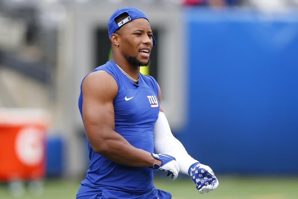 New York Giants running back Saquon Barkley warms up before an NFL preseason football game against the New England Patriots, Sunday, Aug. 29, 2021, in East Rutherford, N.J. (AP Photo/Noah K. Murray)