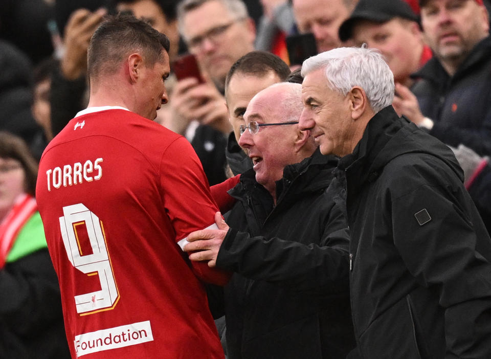 Liverpool Legends' manager Sven-Goran Eriksson (C) and Liverpool Legends' manager Ian Rush (R) congratulate Liverpool Legends' striker Fernando Torres as leaves the pitch after being substituted off during the Legends football match between Liverpool Legends and Ajax Legends at Anfield in Liverpool, north-west England on March 23, 2024. (Photo by Oli SCARFF / AFP) (Photo by OLI SCARFF/AFP via Getty Images)