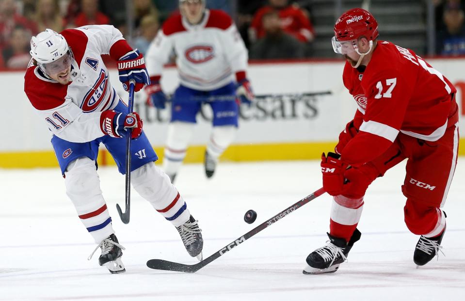 Montreal Canadiens right wing Brendan Gallagher (11) passes the puck against Detroit Red Wings defenseman Filip Hronek (17) during the second period of an NHL hockey game Tuesday, Nov. 8, 2022, in Detroit. (AP Photo/Duane Burleson)