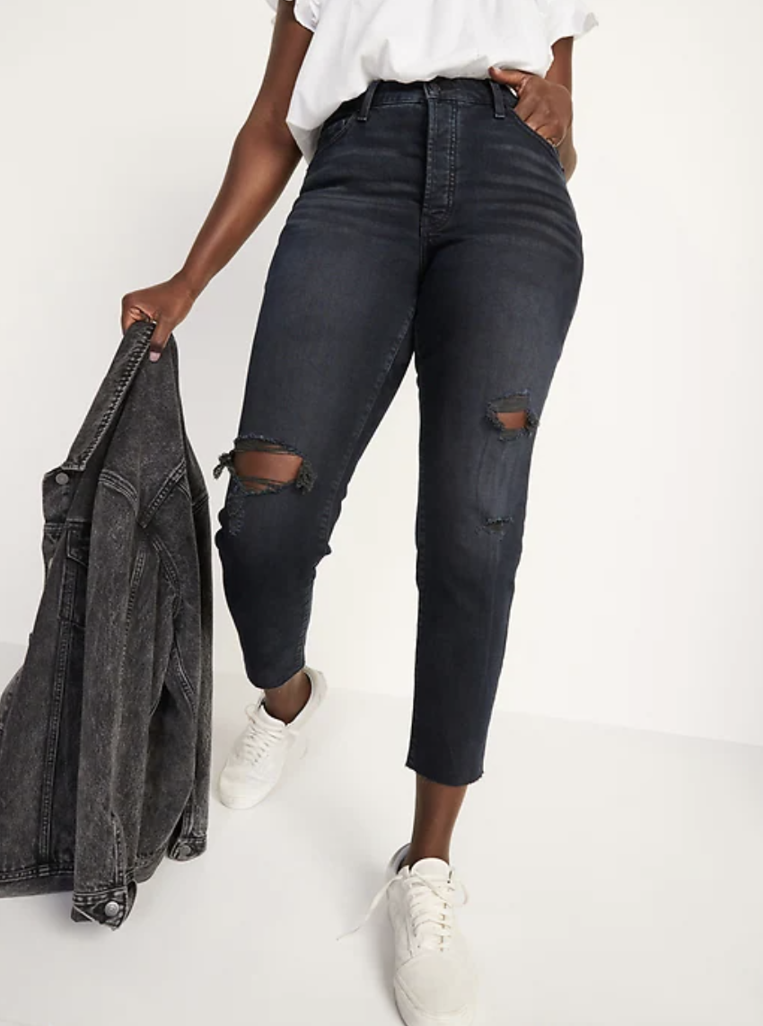 plus size model wearing white sneakers and black High-Waisted O.G. Straight Button-Fly Cut-Off Jeans 