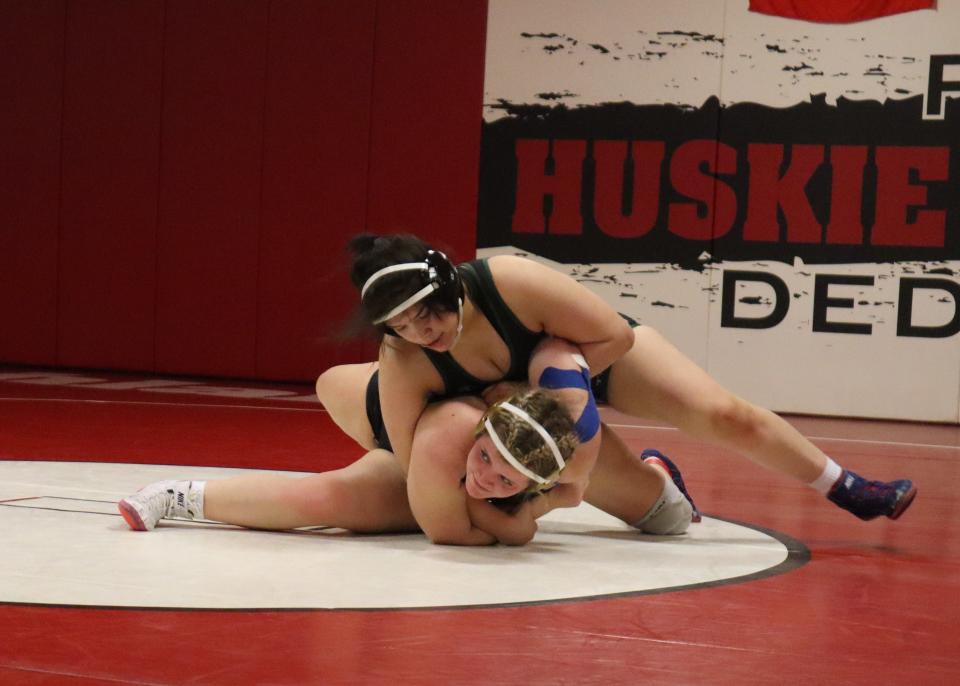 Iowa City West's Jannell Avila wrestles Iowa City Liberty's Eavenly Nielsen during the Highland Tournament.