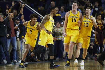 Jan 22, 2019; Ann Arbor, MI, USA; Michigan Wolverines guard Charles Matthews (1) is congratulated by teammates after he hits a game winning basket at the buzzer against the Minnesota Golden Gophers at Crisler Center. Mandatory Credit: Rick Osentoski-USA TODAY Sports