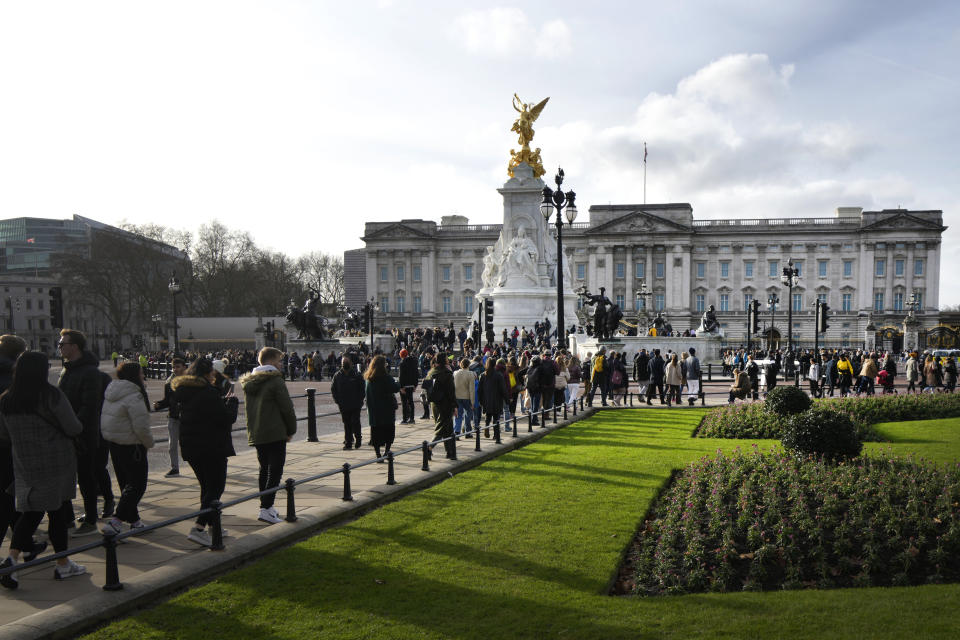 Tourists walk around Buckingham Palace in London, Friday, Jan. 6, 2023. Prince Harry alleges in a much-anticipated new memoir that his brother Prince William lashed out and physically attacked him during a furious argument over the brothers' deteriorating relationship. The book "Spare" also included incendiary revelations about the estranged royal's drug-taking, first sexual encounter and role in killing people during his military service in Afghanistan. (AP Photo/Kirsty Wigglesworth)