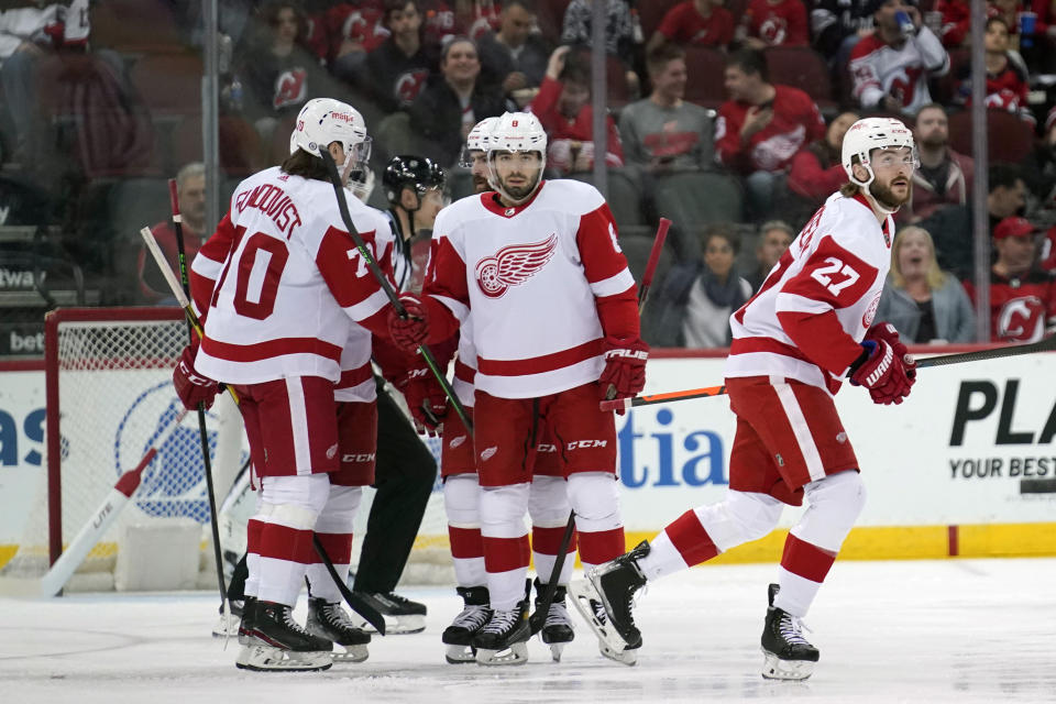 Detroit Red Wings' Michael Rasmussen, right, celebrates his goal during the first period of an NHL hockey game against the New Jersey Devils in Newark, N.J., Friday, April 29, 2022. (AP Photo/Seth Wenig)