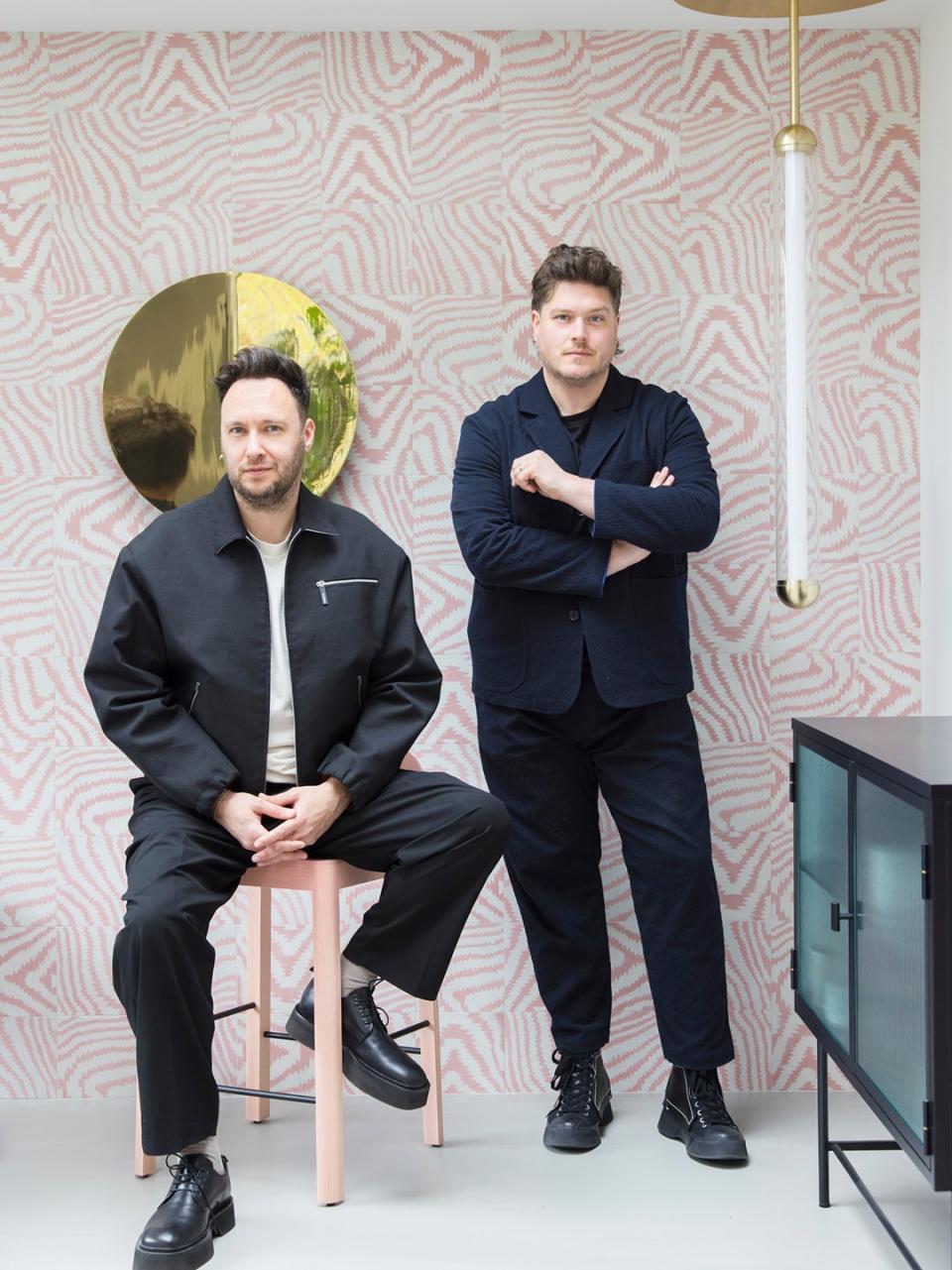 Portrait of 2LG founders Jordan Cluroe and Russel Whitehead behind pink tiled wall. 