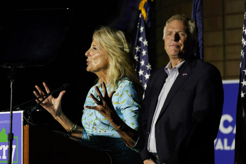 First lady Jill Biden, left, gestures as Democratic gubernatorial candidate Terry McAuliffe looks on during a rally in Richmond, Va., Friday, Oct. 15, 2021. McAuliffe will face Republican Glenn Youngkin in the November election. (AP Photo/Steve Helber)