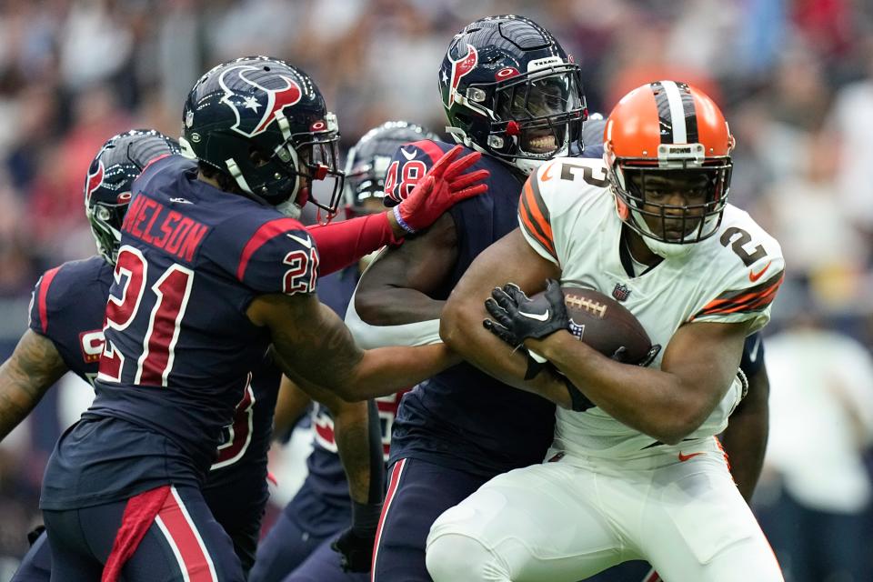 Cleveland Browns wide receiver Amari Cooper (2) is tackled by Houston Texans cornerback Steven Nelson (21) and Christian Harris (48) during the first half of an NFL football game between the Cleveland Browns and Houston Texans in Houston, Sunday, Dec. 4, 2022,. (AP Photo/Eric Gay)