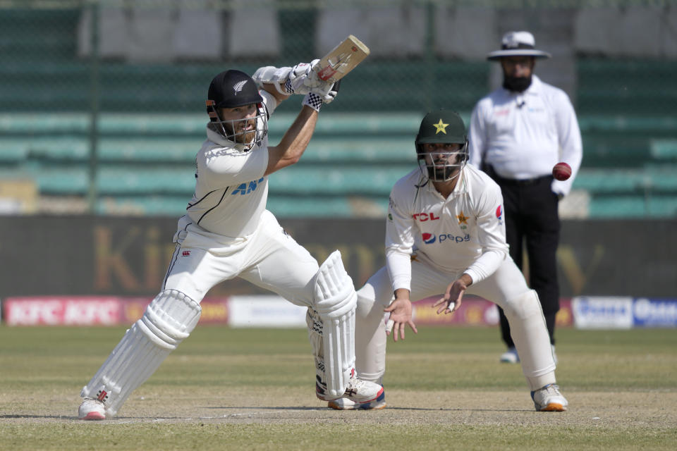 New Zealand's Kane Williamson, left, plays a shot as Pakistan's Abdullah Shafique watches during the fourth day of the second test cricket match between Pakistan and New Zealand, in Karachi, Pakistan, Thursday, Jan. 5, 2023. (AP Photo/Fareed Khan)