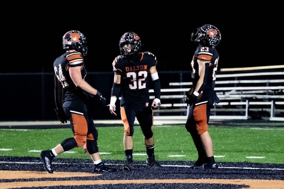 Dalton's Greyson Siders celebrates this touchdown with teammates Collin Jones (64) and Gavin Annen (32).