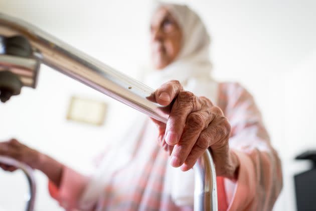 Very old Middle Eastern woman using walker with closeup on hands (Photo: Jasmin Merdan via Getty Images)