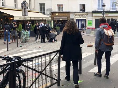 Macron's bodyguard is seen with a May Day protester in Paris, France, May 1, 2018 in this picture grab obtained from social media video. Courtesy of SONIA/via REUTERS