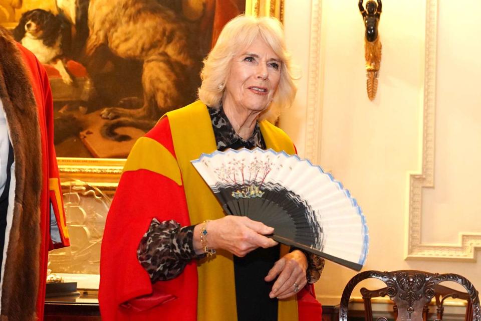 <p>Jordan Pettitt - Pool/Getty</p> Queen Camilla is installed as an Honorary Liveryman of the Worshipful Company of Fan Makers on February 13, 2024 