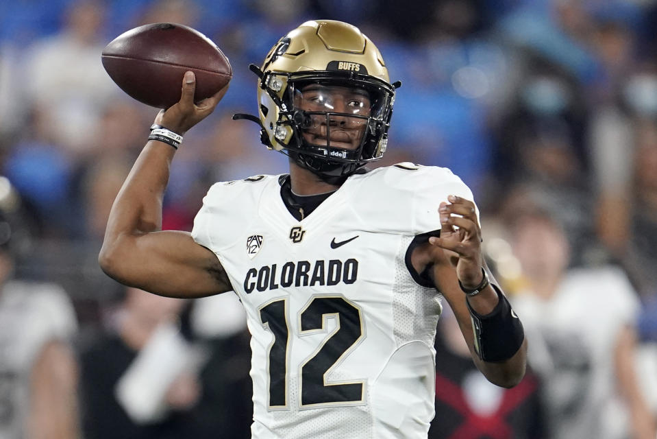 FILE - Colorado quarterback Brendon Lewis throws a pass during the first half of the team's NCAA college football game against UCLA on Nov. 13, 2021, in Pasadena, Calif. Lewis started last season but turned in an up-and-down season where offensive coordinator Darrin Chiaverini was relieved of his duties. Lewis is being pushed by J.T. Shrout, the Tennessee transfer who didn’t play last season after suffering a knee injury last August in camp. (AP Photo/Marcio Jose Sanchez, File)