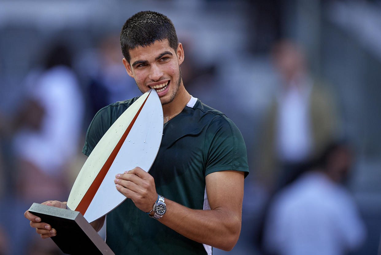 MADRID, SPAIN - MAY 08: Carlos Alcaraz of Spain poses for photographs with the trophy after his victory during the Men's Singles final match against Alexander Zverev of Germany at the day eleven of Mutua Madrid Open at La Caja Magica on May 08, 2022 in Madrid, Spain. (Photo by Pablo Morano/MB Media/Getty Images)