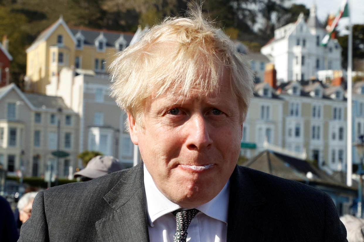 LLANDUDNO, WALES - APRIL 26: Britain's Prime Minister, Boris Johnson eats an ice-cream as he campaigns in Wales ahead of elections on April 26, 2021 in Llandudno, United Kingdom. (Photo by Phil Noble - WPA Pool/Getty Images)