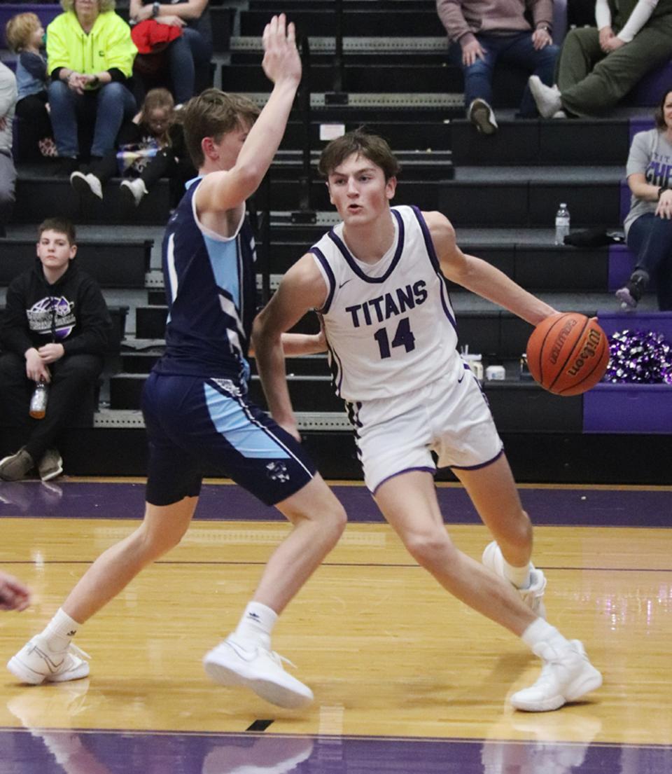 Jonah Funk of El Paso-Gridley drives the baseline against Prairie Central's Talen Steidinger Friday night. Funk had 16 points, 9 rebounds and 10 blocks as the Titans won 62-42.