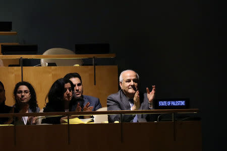 Palestinian Ambassador to the United Nations Riyad Mansour applauds following the adoption of a draft resolution by the United Nations General Assembly to deplore the use of excessive force by Israeli troops against Palestinian civilians at U.N. headquarters in New York, U.S., June 13, 2018. REUTERS/Mike Segar