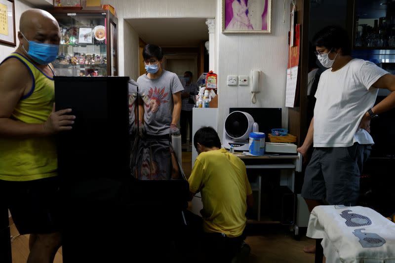 The Wider Image: Leaving Hong Kong: A family makes a wrenching decision