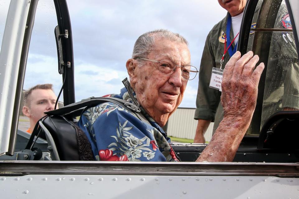 Navy veteran Frank Emond, 101, a Pearl Harbor survivor, waves after getting situated in a T-34 Mentor at the Pensacola Aviation Center on Friday, July 12, 2019, before the start of his Veterans Flight to Pensacola Beach. Emond passed away at age 104.