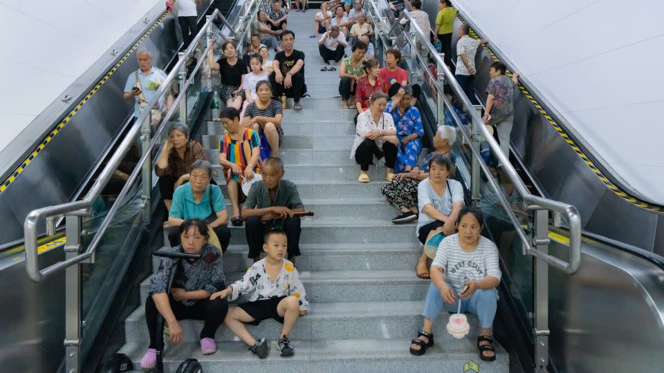 People cool off at a railway platform in Chongqing, China, on July 24, 2024, as temperatures reached 40 degrees Celsius (104 Fahrenheit). - Costfoto/NurPhoto/Getty Images