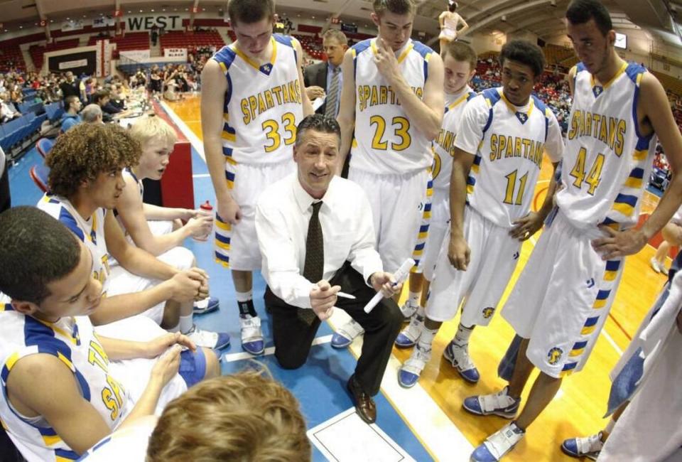 Collegiate head basketball coach Mitch Fiegel talks to his team during a timeout.